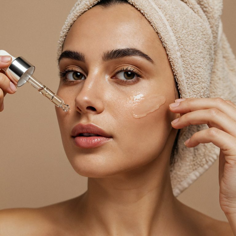 woman-applying-serum-her-face